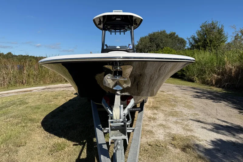 Slide: The Image of 2021 Tidewater 2700 Carolina Bay boat on trailer, grassy area, clear blue sky. - 10