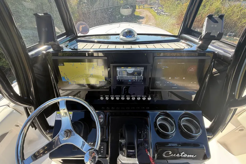 Slide: The Image of 2021 Tidewater 2700 Carolina Bay dashboard with advanced navigation and control systems. - 17