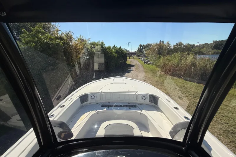 Slide: The Image of 2021 Tidewater 2700 Carolina Bay boat on a scenic riverside path. - 18