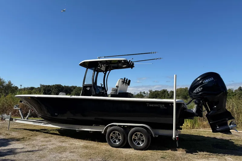 Slide: The Image of 2021 Tidewater 2700 Carolina Bay boat on trailer with Yamaha engine, outdoors. - 2
