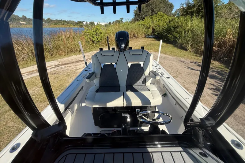 Slide: The Image of 2021 Tidewater 2700 Carolina Bay boat interior with dual seats and steering wheel. - 24