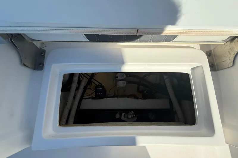 Slide: The Image of Open hatch on 2021 Tidewater 2700 Carolina Bay boat, revealing internal components. - 30