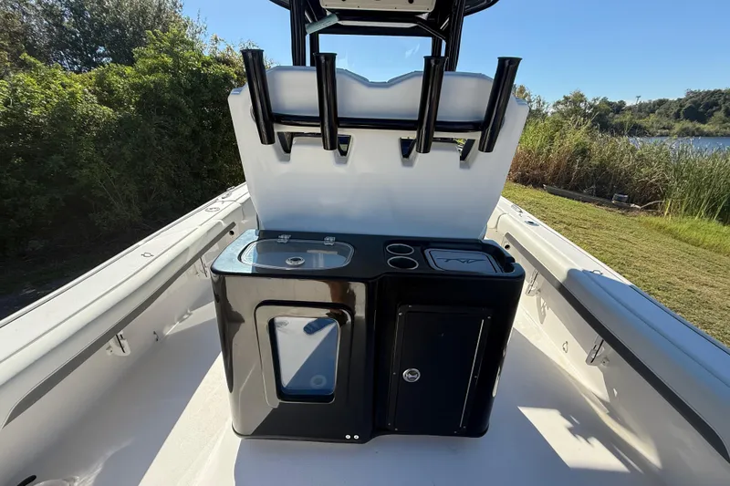Slide: The Image of 2021 Tidewater 2700 Carolina Bay boat interior with rod holders and storage compartments. - 32