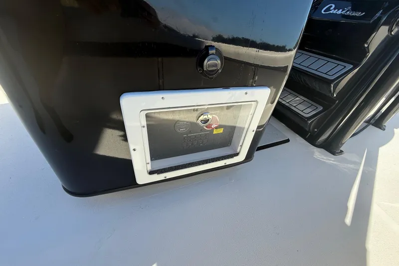 Slide: The Image of 2021 Tidewater 2700 Carolina Bay boat console with storage compartment and steps. - 35