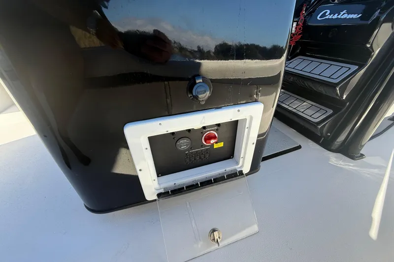 Slide: The Image of Control panel on a 2021 Tidewater 2700 Carolina Bay boat, featuring a sleek black design. - 36