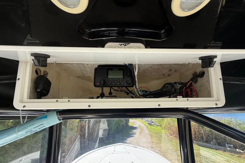 Slide: The Image of 2021 Tidewater 2700 Carolina Bay boat console with electronic equipment and wiring. - 40