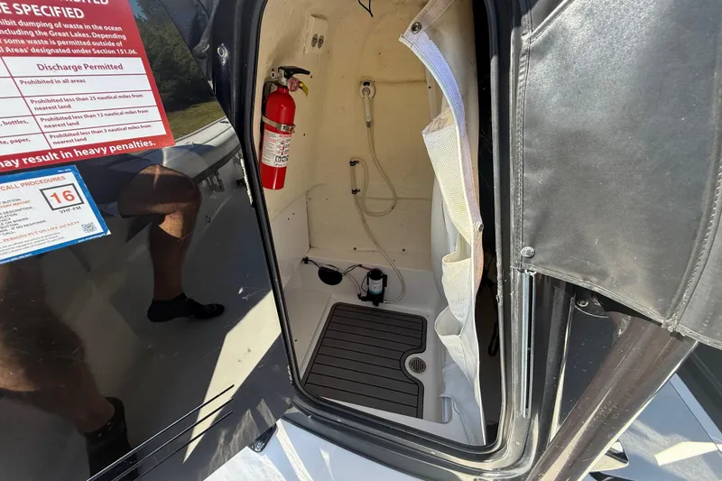 Slide: The Image of Interior of 2021 Tidewater 2700 Carolina Bay boat with fire extinguisher and safety instructions. - 42