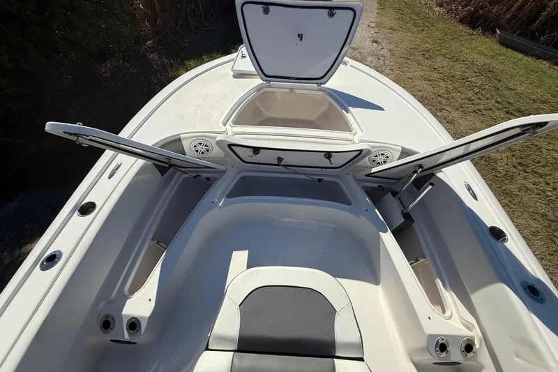 Slide: The Image of 2021 Tidewater 2700 Carolina Bay boat with open storage compartments and seating area. - 45