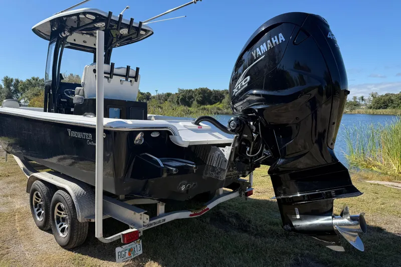 Slide: The Image of 2021 Tidewater 2700 Carolina Bay boat with Yamaha engine on trailer by a lake. - 5