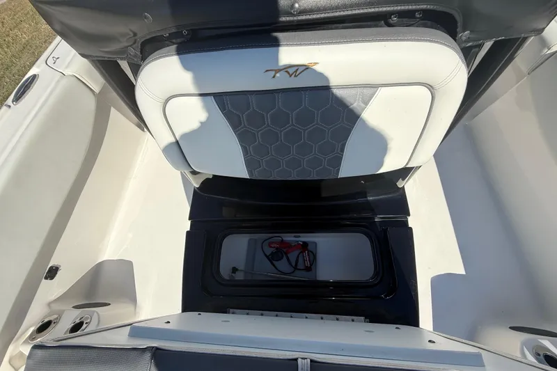 Slide: The Image of 2021 Tidewater 2700 Carolina Bay boat interior with storage compartment and seat detail. - 51