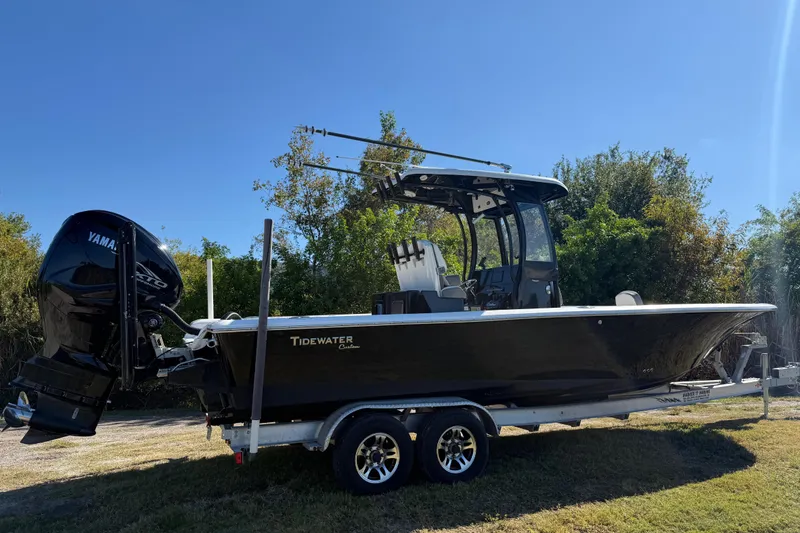Slide: The Image of 2021 Tidewater 2700 Carolina Bay boat on trailer with Yamaha engine, parked outdoors. - 7
