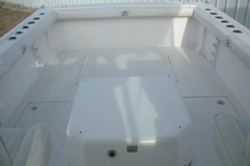 Slide: The Image of 2005 Baha Cruisers 299 SF boat interior, featuring spacious white deck and seating area. - 18