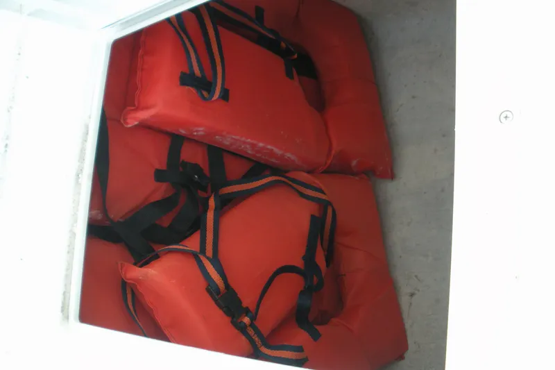 Slide: The Image of Red life jackets stored in a compartment on a 2005 Baha Cruisers 299 SF boat. - 21