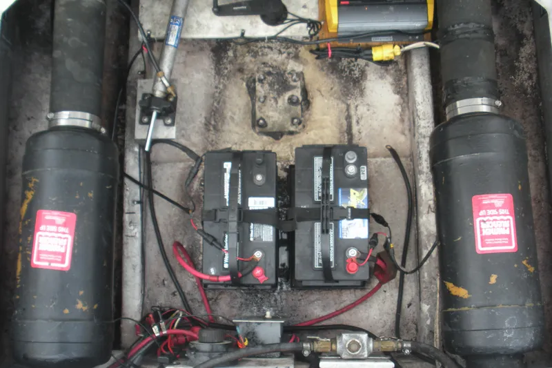 Slide: The Image of 2005 Baha Cruisers 299 SF engine compartment with batteries and wiring. - 25