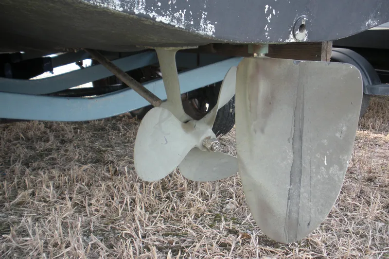 Slide: The Image of Propeller and rudder of 2005 Baha Cruisers 299 SF boat on dry grass. - 28