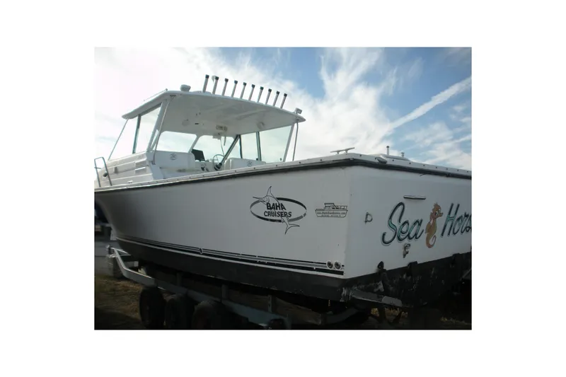 Slide: The Image of 2005 Baha Cruisers 299 SF boat on trailer under a cloudy sky. - 5