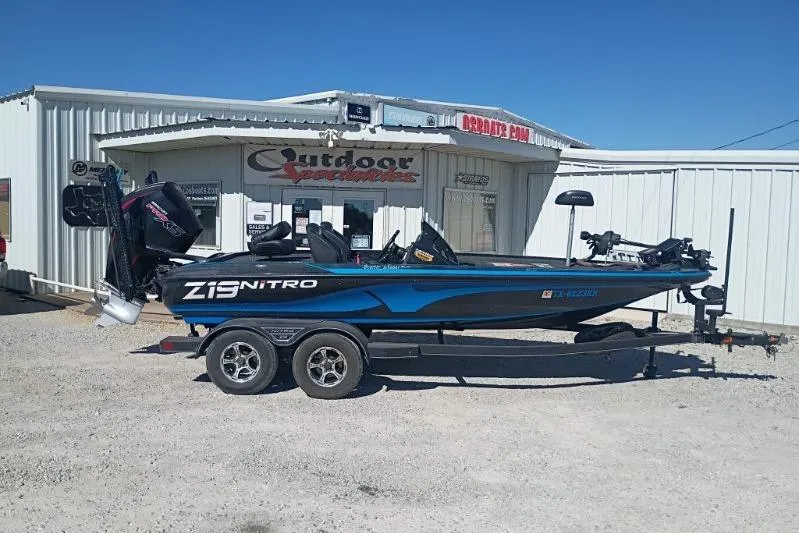 The Image of 2022 Tracker Z19 Nitro boat on trailer outside Outdoor Specialties store. - 1