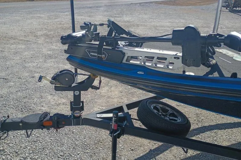 Slide: The Image of 2022 Tracker boat on trailer with Minn Kota motor, parked on gravel surface. - 10