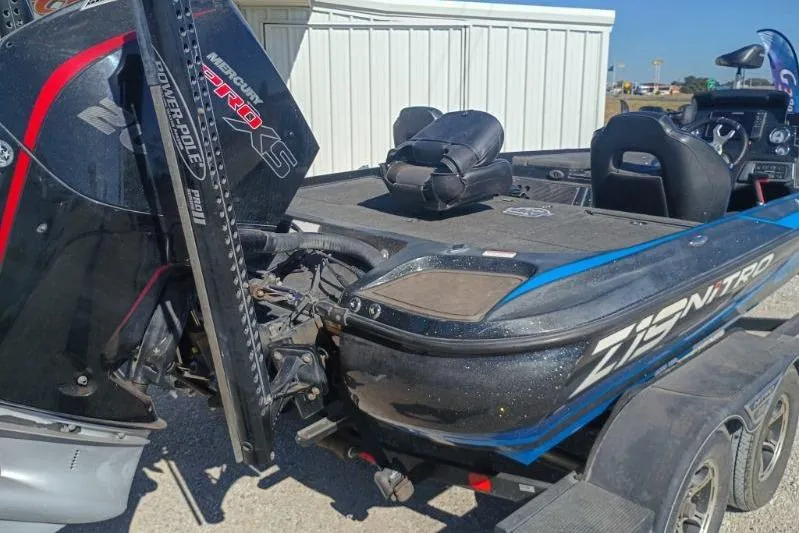 Slide: The Image of 2022 Tracker boat with Mercury engine and Power-Pole, parked on trailer. - 6