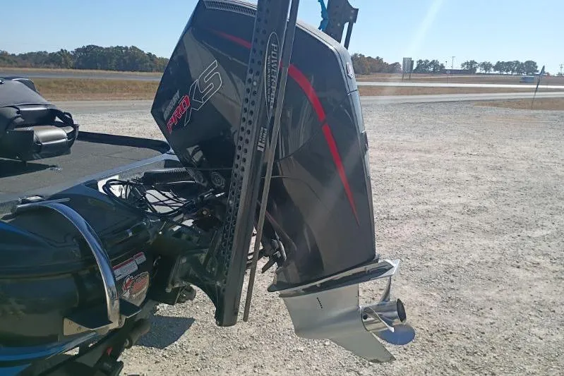 Slide: The Image of 2022 Tracker boat engine with Pro XS branding in a sunny outdoor setting. - 8