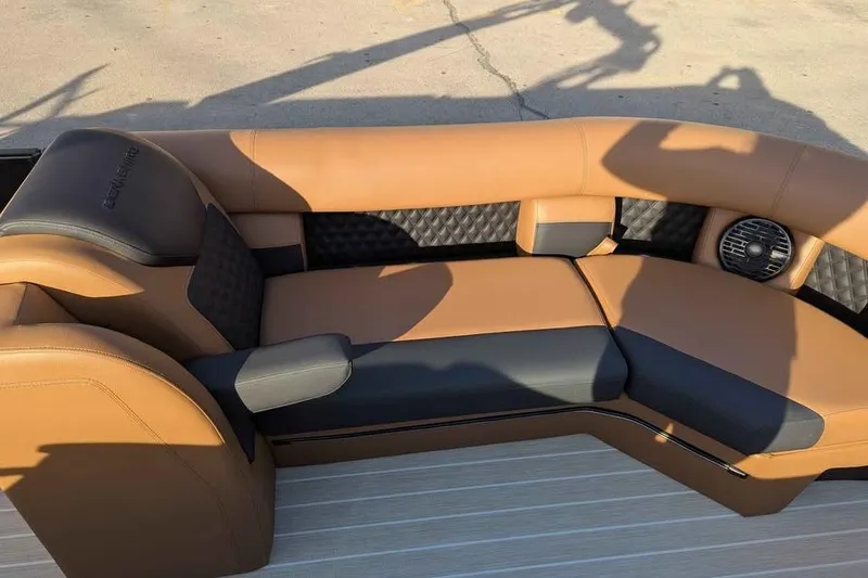 Slide: The Image of Luxurious seating on 2026 Berkshire 25SB2 STS 3.0 boat, featuring tan and black upholstery. - 16