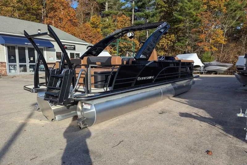 Slide: The Image of 2026 Berkshire 25SB2 STS 3.0 pontoon boat in a dealership lot, surrounded by autumn trees. - 4