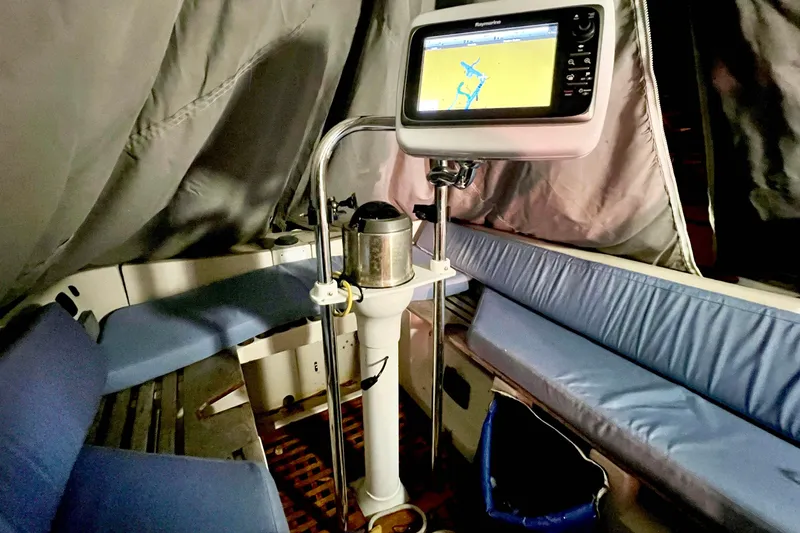 Slide: The Image of Interior of 1981 Beneteau First 32 sailboat with navigation equipment and blue seating. - 7