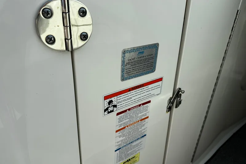 Slide: The Image of 2008 Chaparral 256 SSi yacht certification and warning labels on white panel. - 10