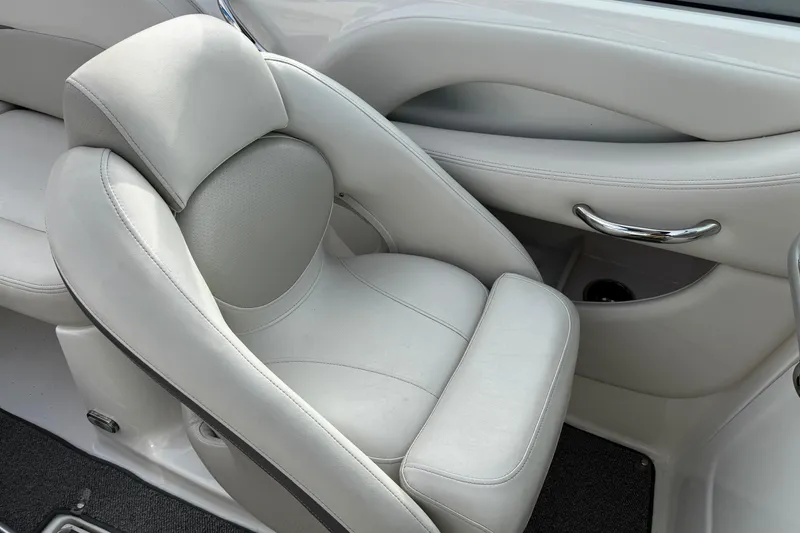 Slide: The Image of 2008 Chaparral 256 SSi boat interior with plush white seating and chrome accents. - 12