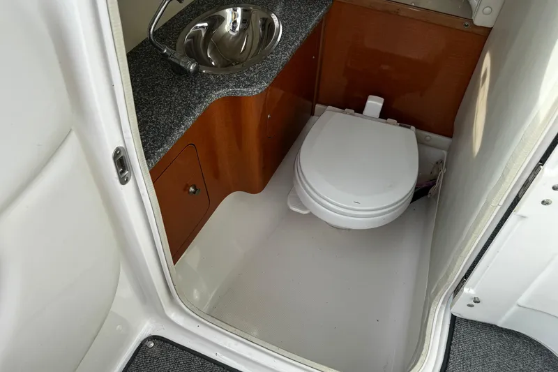 Slide: The Image of 2008 Chaparral 256 SSi boat bathroom with sink and toilet. - 15