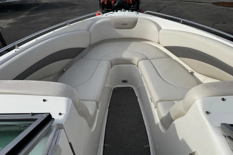 Slide: The Image of 2008 Chaparral 256 SSi boat interior with white cushioned seating and gray accents. - 16
