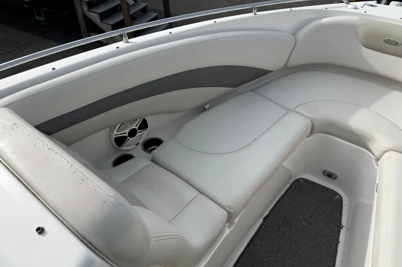 Slide: The Image of 2008 Chaparral 256 SSi boat interior with white seating and speaker system. - 18