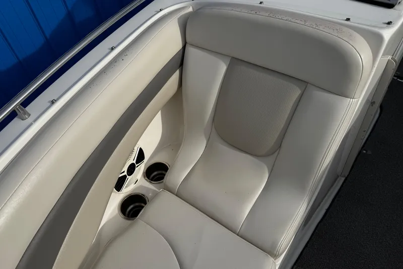 Slide: The Image of 2008 Chaparral 256 SSi boat interior with white seating and cup holders. - 23