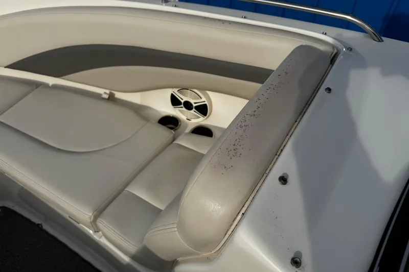 Slide: The Image of 2008 Chaparral 256 SSi boat interior with white seating and speaker detail. - 26