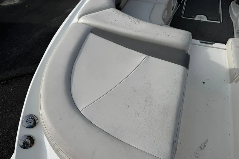 Slide: The Image of 2008 Chaparral 256 SSi boat interior with white cushioned seating. - 31