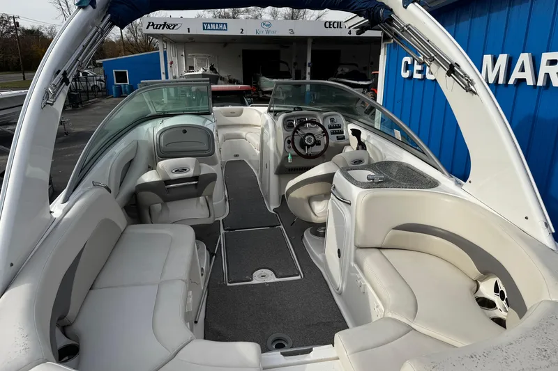 Slide: The Image of 2008 Chaparral 256 SSi boat interior with seating and steering wheel, docked at marina. - 32