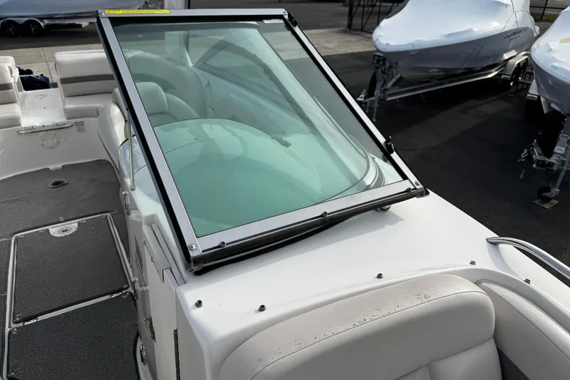 Slide: The Image of 2008 Chaparral 256 SSi boat interior with windshield and seating area. - 34