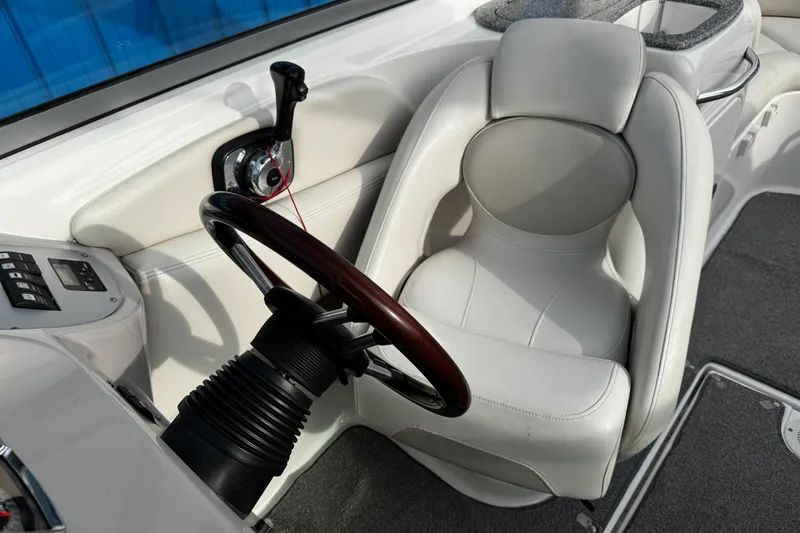 Slide: The Image of 2008 Chaparral 256 SSi boat cockpit with white leather seat and steering wheel. - 35