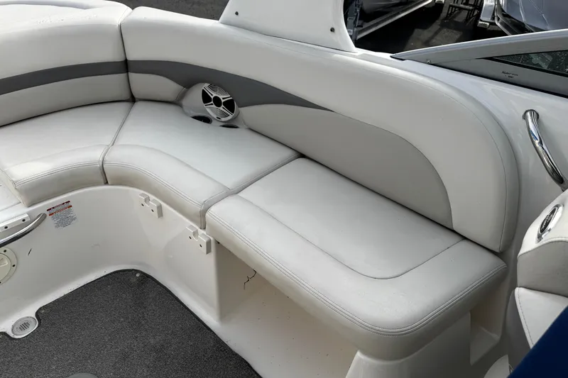 Slide: The Image of 2008 Chaparral 256 SSi boat interior with white cushioned seating and speaker. - 6