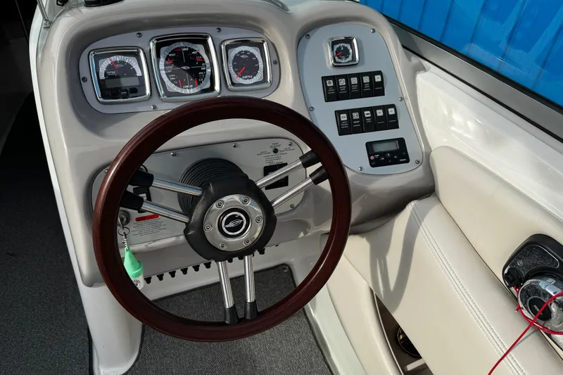 Slide: The Image of Dashboard of 2008 Chaparral 256 SSi boat with steering wheel and control panel. - 9