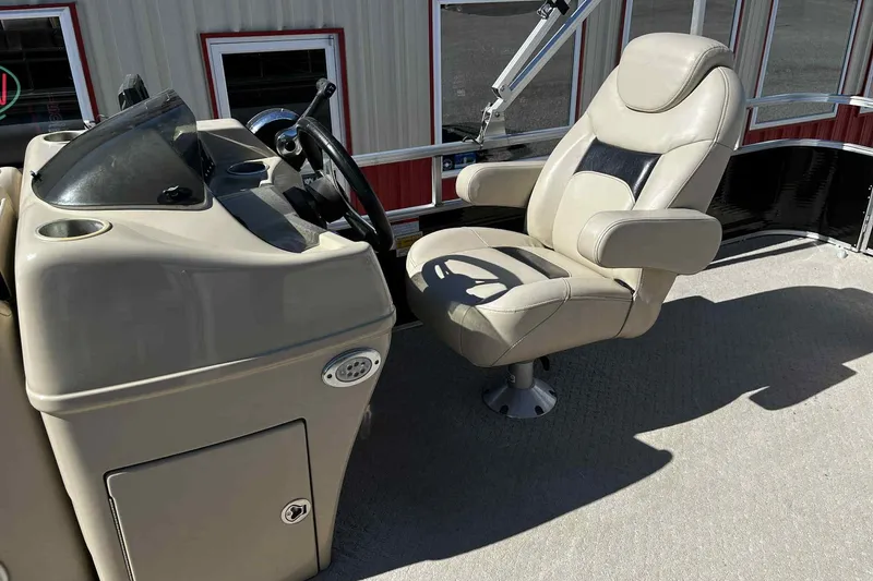 Slide: The Image of 2015 Lowe SS 210 boat interior with beige seating and storage compartments. - 11