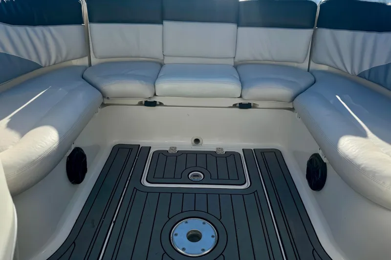 Slide: The Image of 2005 Yamaha Boats SX230 interior with cushioned seating and sleek flooring. - 10