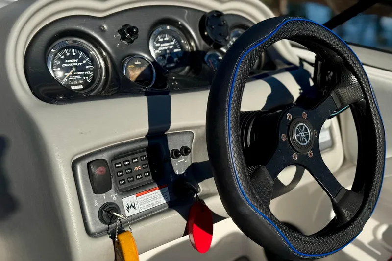 Slide: The Image of 2005 Yamaha Boats SX230 dashboard with steering wheel and control panel. - 2