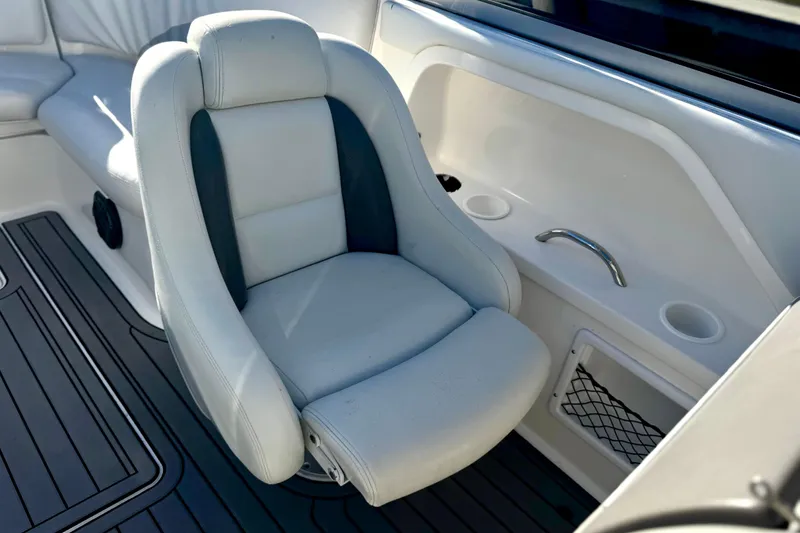 Slide: The Image of 2005 Yamaha Boats SX230 interior with white and gray seating, cup holders, and storage. - 8