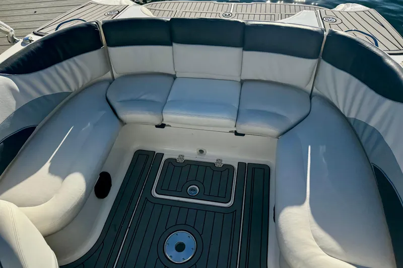 Slide: The Image of 2005 Yamaha Boats SX230 interior seating with cushioned upholstery and deck flooring. - 9