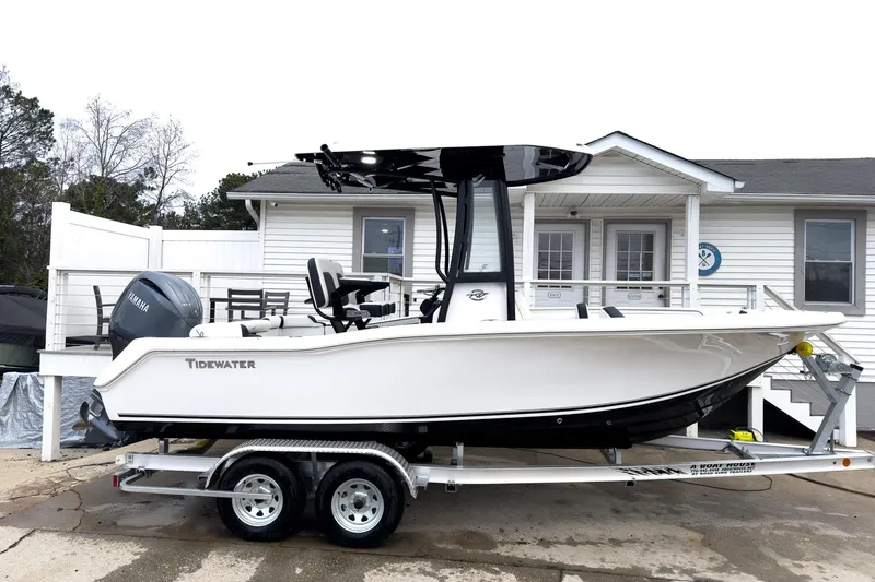 The Image of 2026 Tidewater 210 LXF boat on trailer, parked outside a white house. - 0