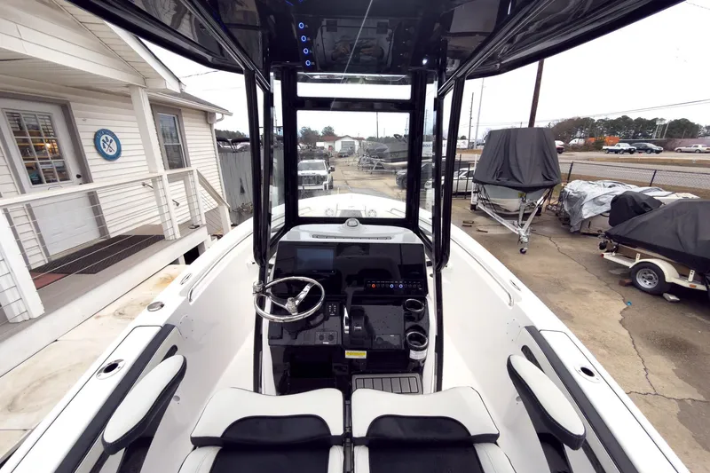 Slide: The Image of 2026 Tidewater 210 LXF boat interior with steering wheel and control panel. - 10