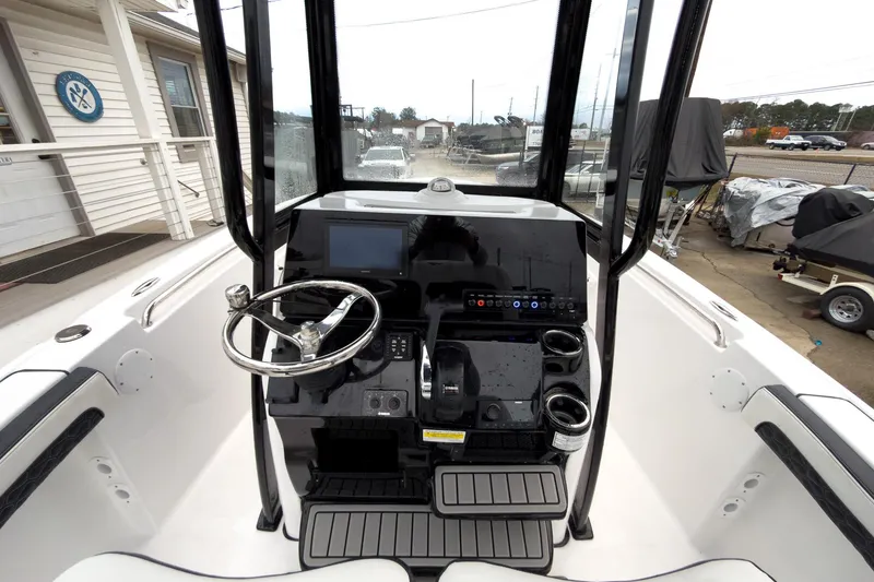 Slide: The Image of 2026 Tidewater 210 LXF boat console with steering wheel and control panel. - 11