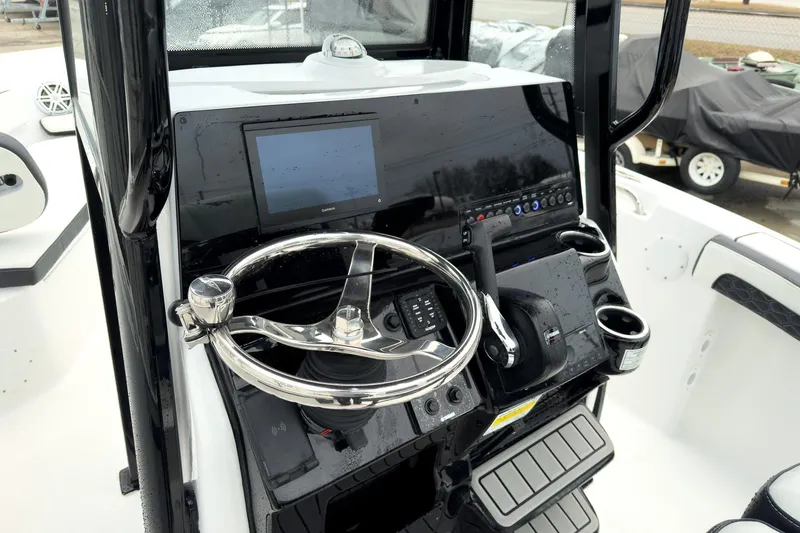 Slide: The Image of 2026 Tidewater 210 LXF boat console with steering wheel and navigation display. - 12