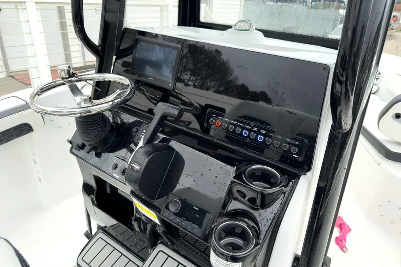 Slide: The Image of 2026 Tidewater 210 LXF boat dashboard with steering wheel and control panel. - 14